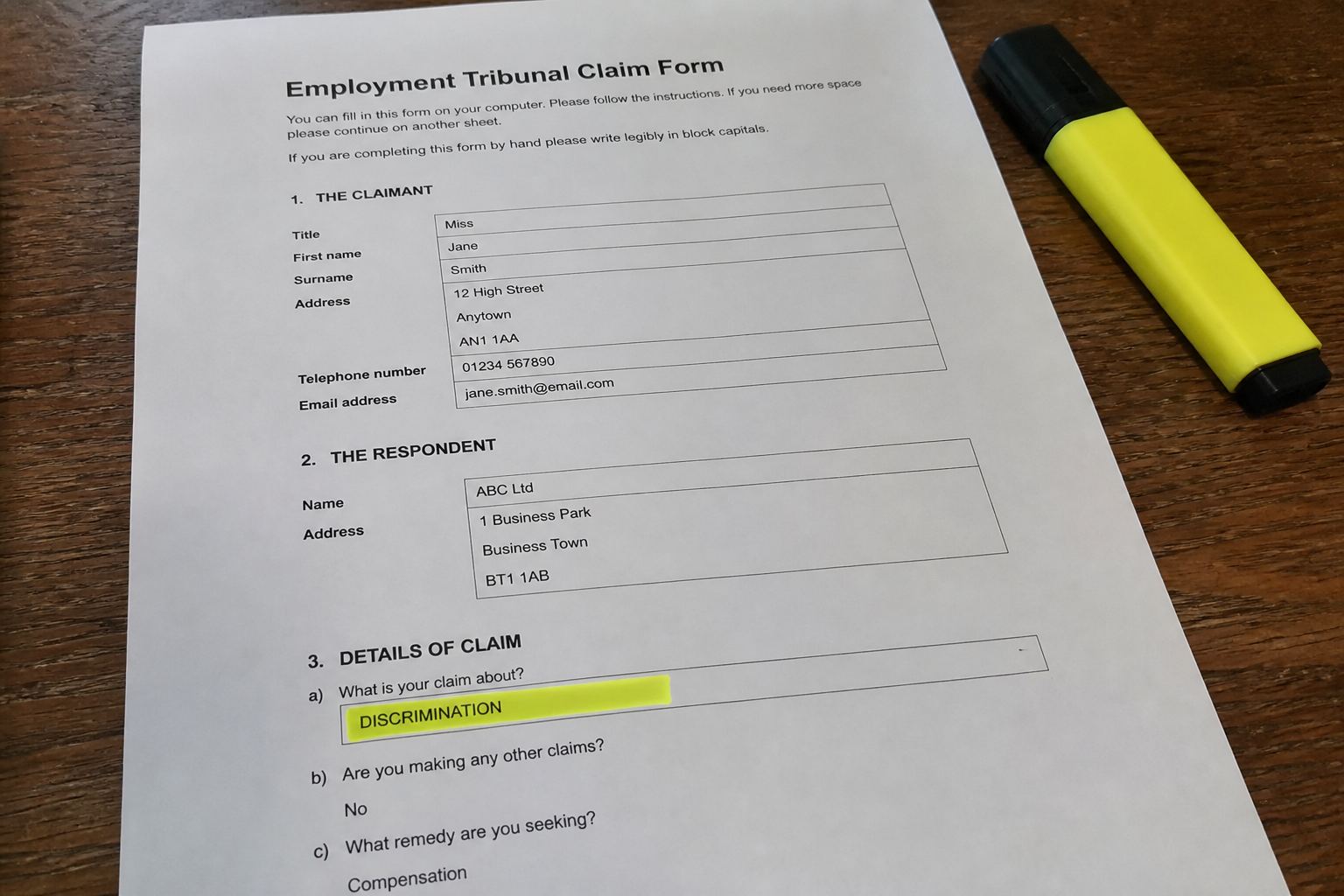 A printed discrimination claim form on a kitchen table.